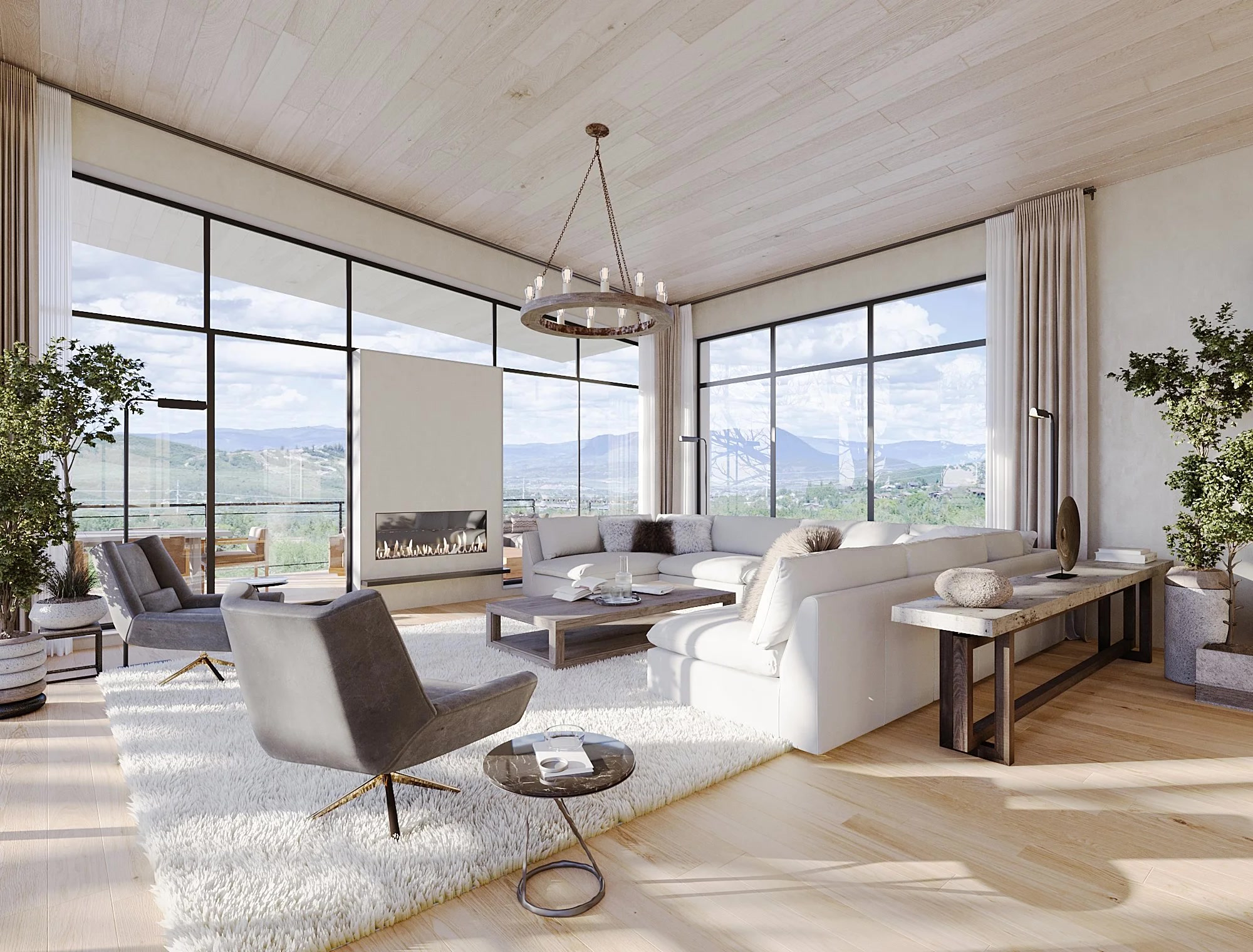 Modern mountain great room with chandelier, floor-to-ceiling windows, and Colorado mountain views