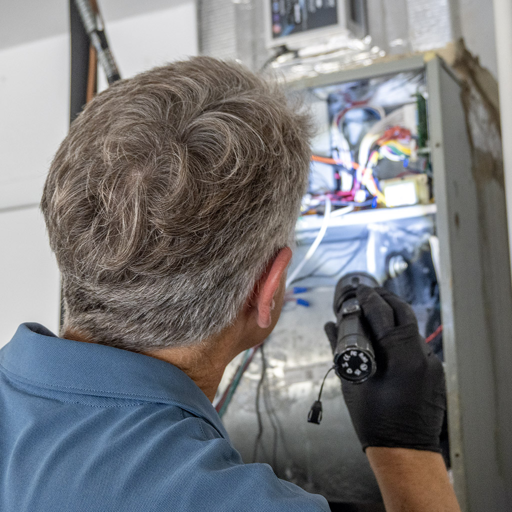 Checking an electrical panel for errors with a flashlight