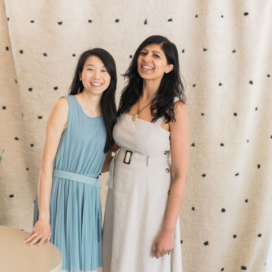Sandy Wong with her supplier partner in front of a hand-woven rug