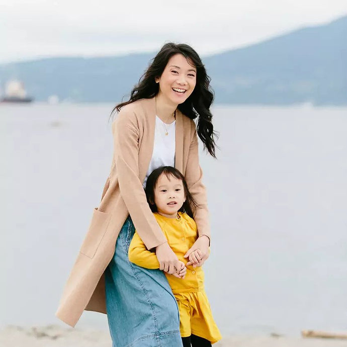 Sandy Wong with her child on a Vancouver beach